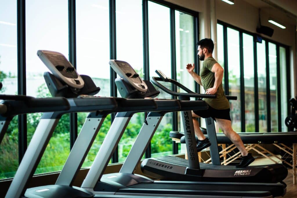 Runner on treadmill in gym setting