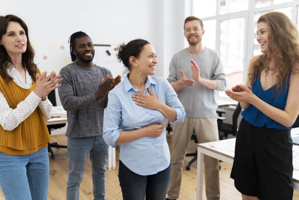 employees cheering in office Navigating Workplace Change